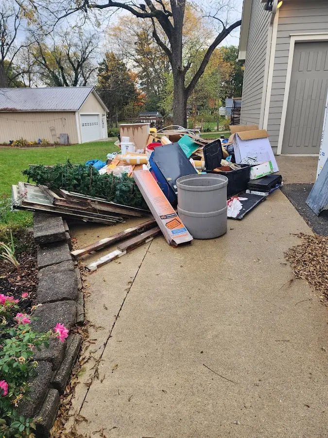 Dumpster being loaded with debris for Estate Cleanout Dumpster Rental in Tulare